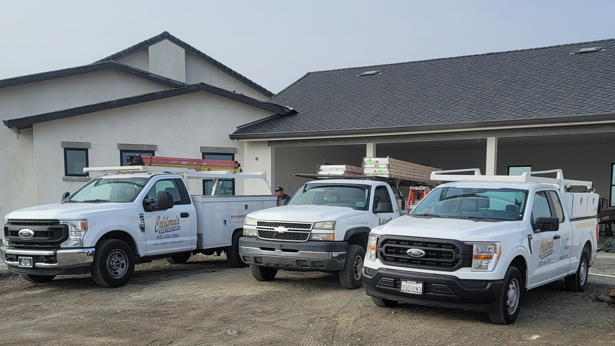 California Overhead Door service trucks on a job site in Hollister, CA